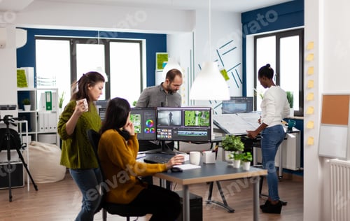 Preview: Colleagues discussing about video project adjusting film footage