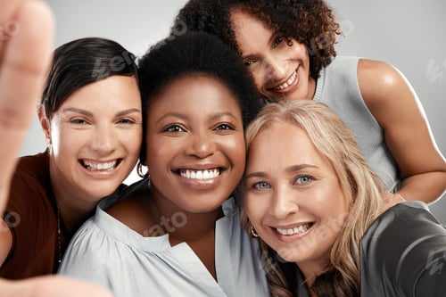 Preview: Shot of a diverse group of women standing close together in the studio and take a selfie