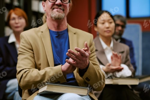 Preview: Diverse Group of Adults Applauding during Book Presentation Event