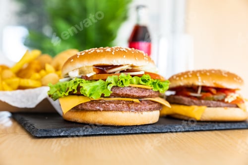 Preview: Assorted of burger and cola in the interior of cafe. Unhealthy street food. Fast food