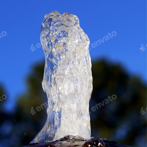 Preview: Water Fountain - Photograph Of Water Coming Up From The Top Of A Fountain With Trees And A Blue Sky