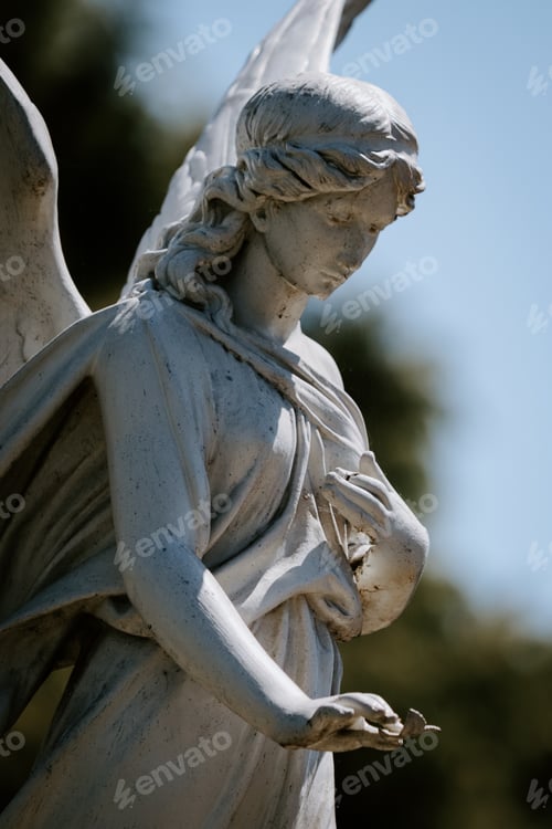 Preview: Vertical shot of a female angel statue with a blurred background