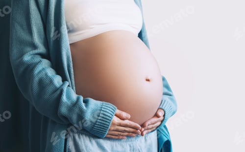 Preview: Pregnant woman holds hands on her belly. Pregnancy, maternity, preparation and expectation concept.