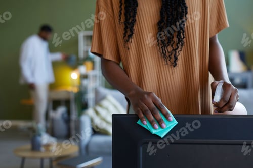 Preview: Woman wiping dust from furniture