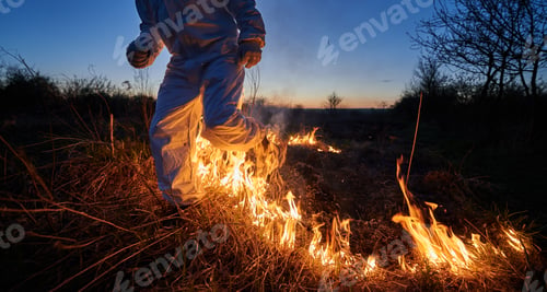 Preview: Firefighter ecologist working in field with wildfire.