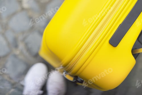 Preview: Travel tourism concept, close up of yellow plastic polycarbonate suitcase