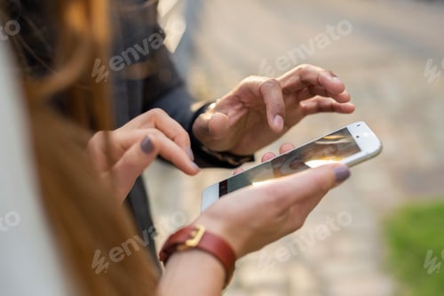 Preview: Man and woman using smart phone