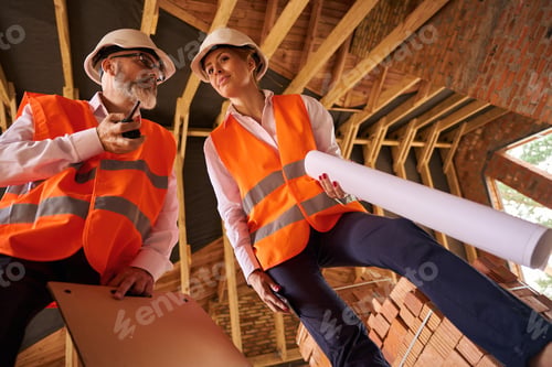 Preview: Building inspector and contractor inspecting unfinished residential house