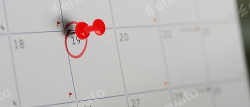 Preview: Close up of a red pushpin marking the 19th on a calendar, symbolizing an important appointment