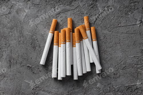 Preview: Concept of addiction to smoking, whole cigarettes, pile on the table.