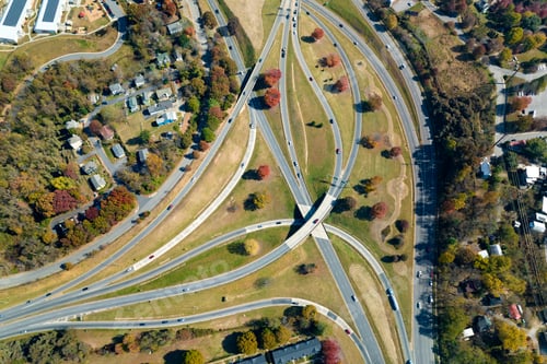 Preview: Aerial view of american freeway intersection with fast moving cars and trucks.