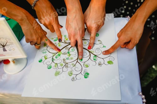 Preview: Tree of footprints in a wedding with fingers of people painting.