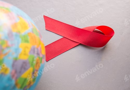 Preview: World AIDS day 1 December, close-up of world globe with red ribbon