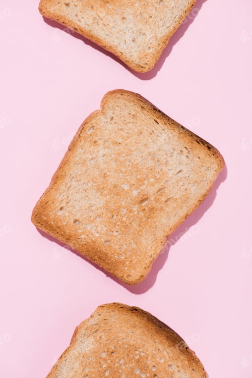 Preview: top view of row of delicious toasts on pink tabletop