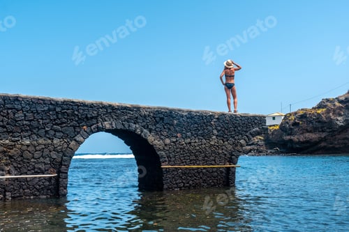 Preview: young woman on vacation in the seaside tourist village Tamaduste on the island of El Hierro
