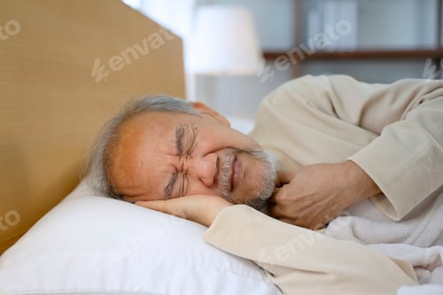 Preview: Senior man is sick and sleeping in bedroom.