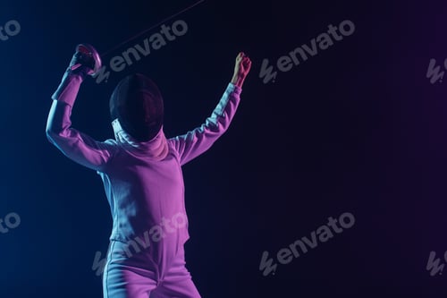 Preview: Fencer in fencing mask holding rapier while showing yes gesture isolated on black