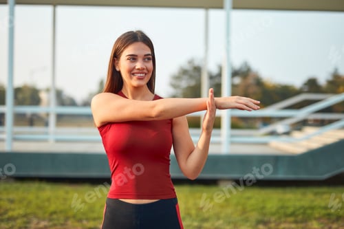 Preview: Young Woman Exercising / Stretching In Urban Park.