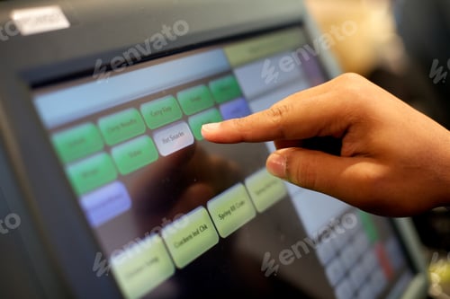 Preview: Closeup photo of a person using a till.