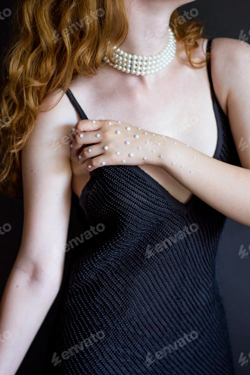Preview: Photo Female Figure In A Black Dress With A Hand In Pearls On A Gray Background