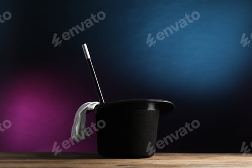 Preview: Magician's hat, gloves and wand on wooden table against dark background