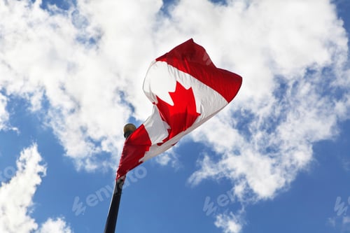 Preview: Canadian flag waving against a striking blue sky
