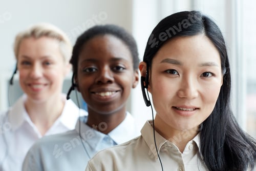 Preview: Smiling Asian Operator Standing in Row