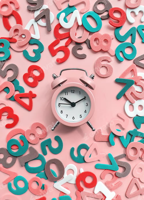 Preview: Pink alarm clock on pink background with colorful numbers flat lay. Back to school concept