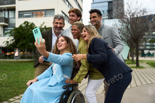 Preview: Diverse business team taking selfie outdoors, celebrating success and inclusion