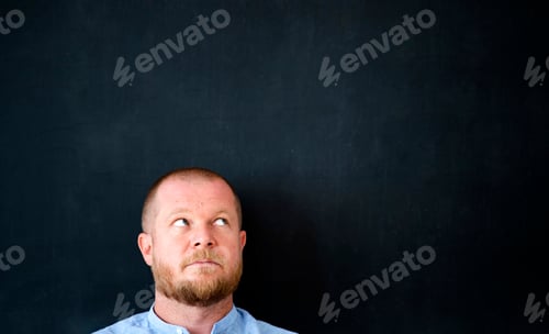 Preview: Businessman in front of the blank blackboard