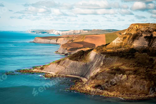 Preview: Vast body of water with a towering cliff in the Jurassic coast in Great Britain