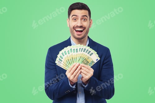 Preview: Young man holding fan of euro notes in cash that he is lottery winne