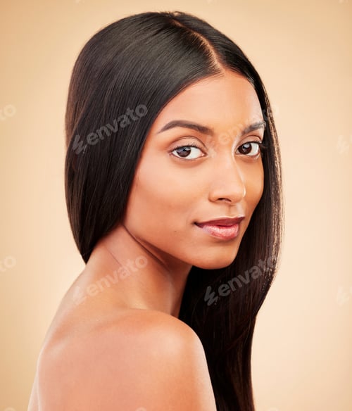 Preview: Portrait, hair care and woman with cosmetics, shine and treatment on a brown studio background. Fac