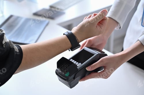 Preview: Customer using smart watch for payment at coffee shop.