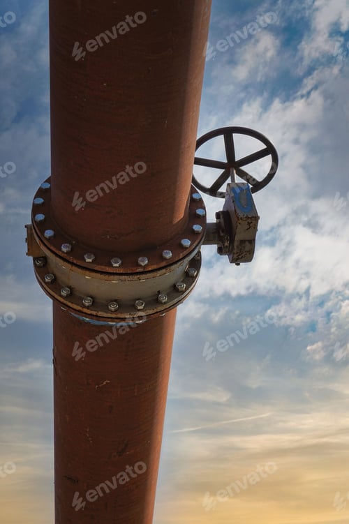 Preview: Vertical low-angle shot of a pipeline against the sky