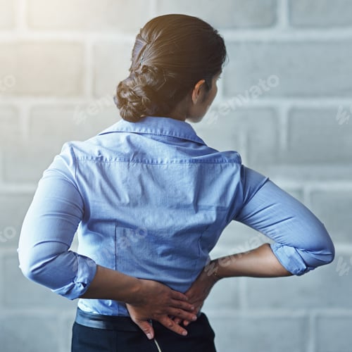 Preview: The aches and pains of a long work day. Rearview shot of a businesswoman suffering from back pain.