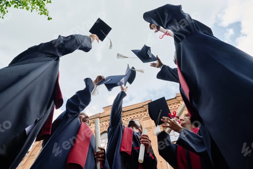 Preview: Happy graduated students throwing hats
