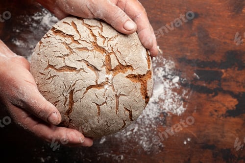 Preview: Baker holding fresh baked homemade bread