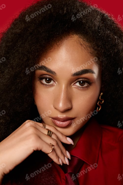 Preview: Stylish African American woman showcases autumn fashion in vibrant studio setting