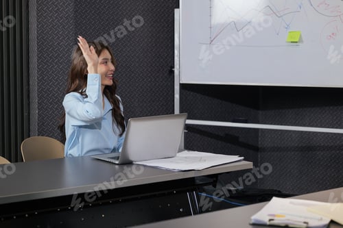 Preview: Business woman in meeting, raising hand, contributing to productive team work project, laptop and