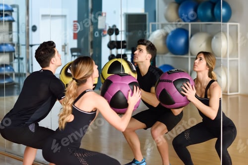 Preview: Man and Woman liftting with in the gym.