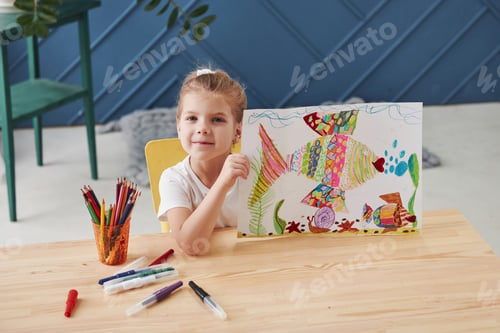 Preview: Cute little girl in art school shows her first paintings drawn by pencils and markers