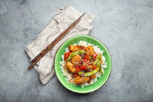 Preview: Asian sweet and sour sticky chicken with vegetables stir-fry and rice in ceramic bowl with