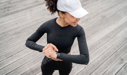 Preview: A smart watch with pulse and cardio, a female trainer trains outside in sportswear.