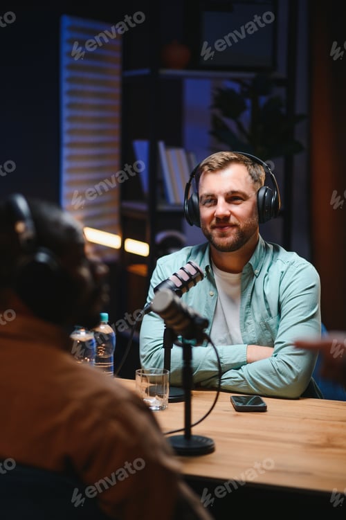 Preview: Man podcaster influencer blogger smiling while broadcasting his live audio podcast