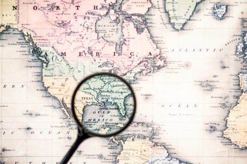 Preview: top view of magnifying glass on world map over gulf mexico