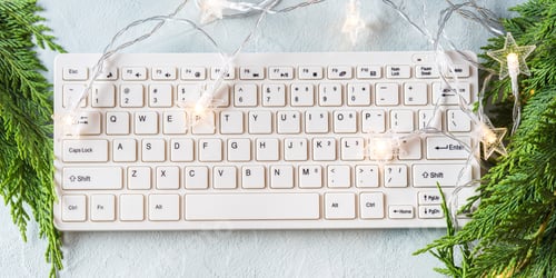 Preview: Workplace winter background with keyboard on gray background with branches