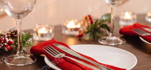 Preview: Christmas table setting. Plate and cutlery on red napkin.