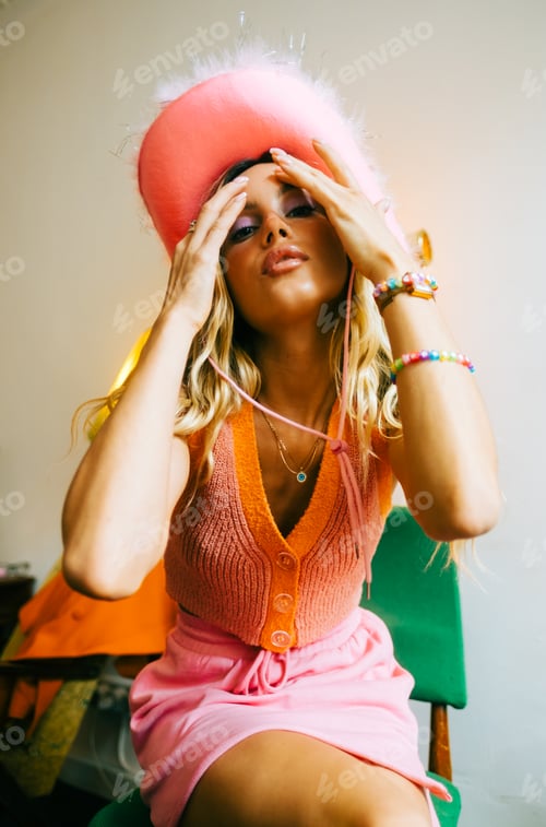 Preview: Portrait of attractive caucasian woman fashion model with blonde hair in pink cowboys hat , posing