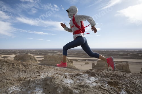 Preview: Fitness woman running in desert